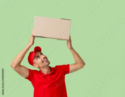 Male courier with parcel on...