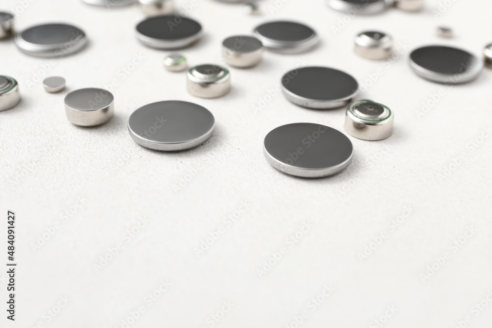 Metal lithium button cell batteries on white background, closeup Metal lithium button cell batteries on white background, closeup