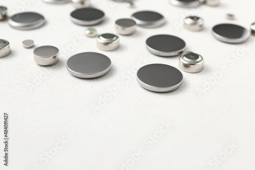 Metal lithium button cell batteries on white background, closeup