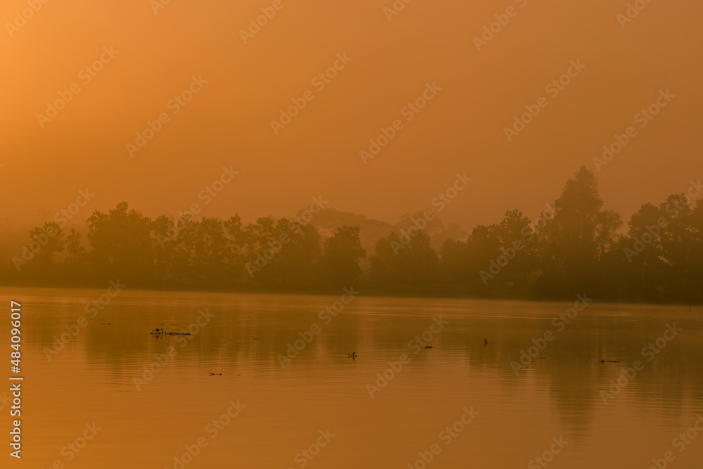 Fototapeta premium The background of the sea by the evening sea, with natural beauty (sea water, rocks, sky) and fishermen are fishing by the river bank, is a pleasure during travel.