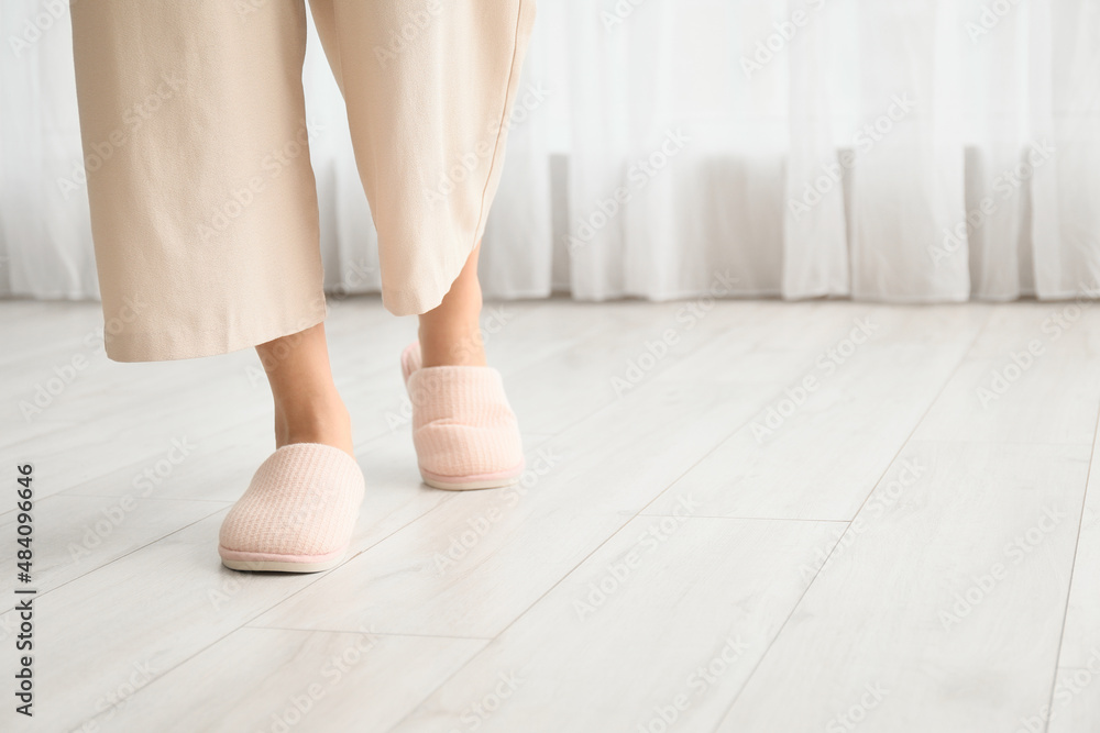 Young woman in soft comfortable slippers at home Young woman in soft comfortable slippers at home