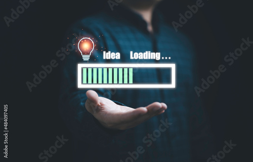 Businessman holding virtual download icon with lightbulb for show status progress of creative thinking idea and problem solving concept.