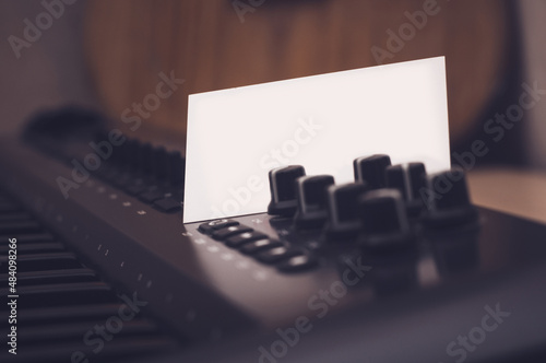 Mockup of a business card that sticks out in a synthesizer or midi keyboard