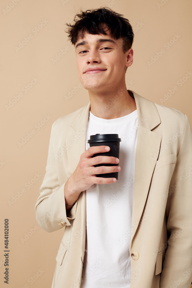 Photo young boyfriend a glass with a drink in hand modern style isolated background unaltered Photo young boyfriend a glass with a drink in hand modern style isolated background unaltered