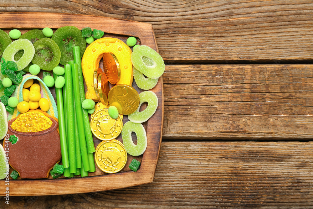 Board with different sweets for St. Patrick's Day celebration on wooden background, closeup Board with different sweets for St. Patrick's Day celebration on wooden background, closeup