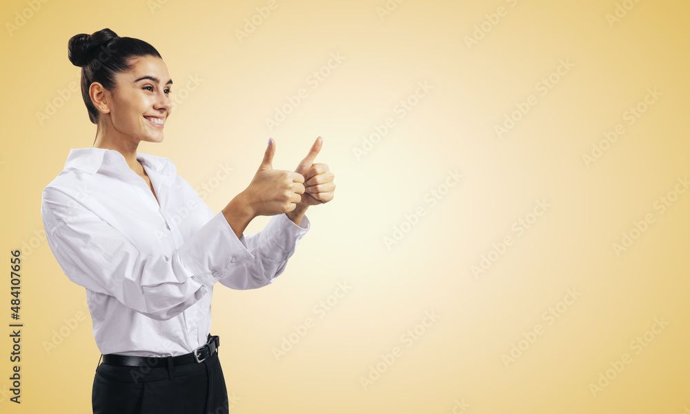 Like concept with happy young woman in white shirt holding thumbs up on abstract light orange background with copyspace, mockup Like concept with happy young woman in white shirt holding thumbs up on abstract light orange background with copyspace, mockup