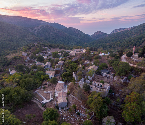 Aerial drone view of Old Perithia, Corfu's oldest village, incredible ruins of stone build houses, close to Mount Pantokrator, abandoned village of Sinies. Greece. photo