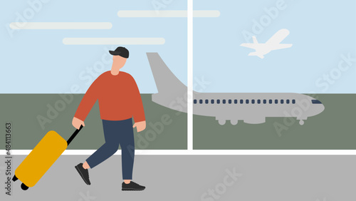 Male traveler pulling suitcase in airport terminal