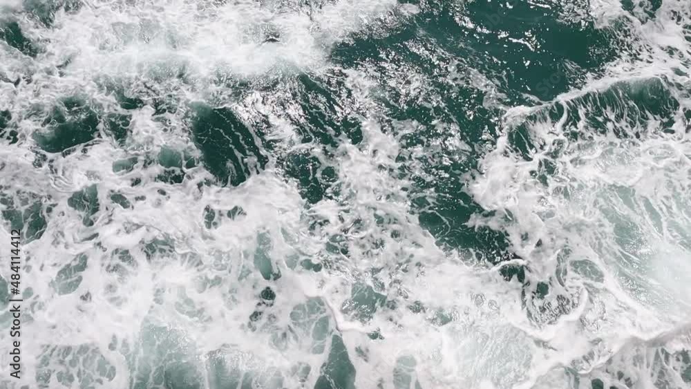 beautiful surface of a wave foam and bubbles on sea water beautiful surface of a wave foam and bubbles on sea water