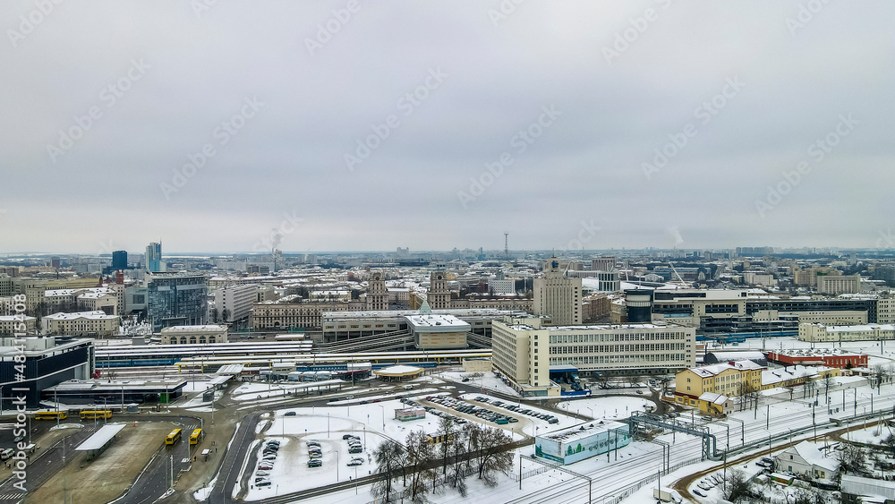 Aerial view of city transport hub railway and bus station. Aerial Central railroad station yard area in Minsk in winter.