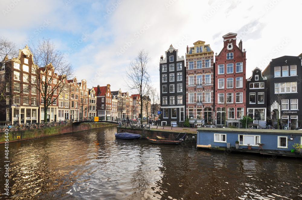 Amsterdam canal with typical dutch houses and houseboats