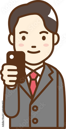 A man in a suit holding a cell phone.