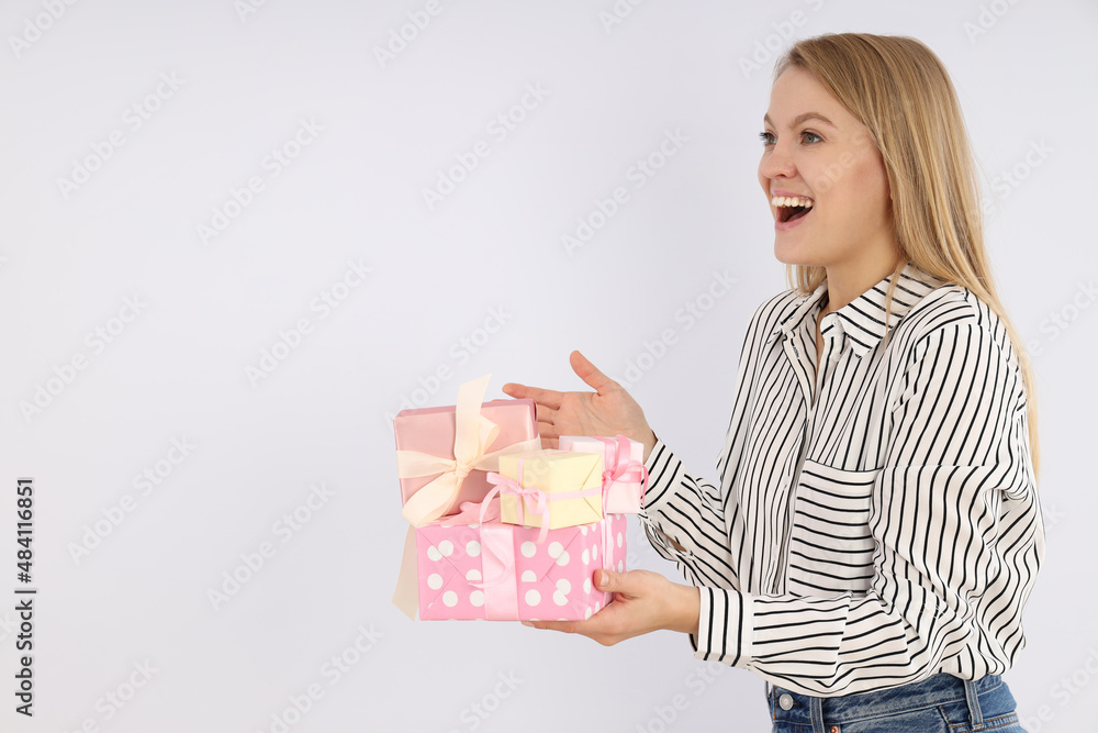Young woman with gift boxes on white background Young woman with gift boxes on white background