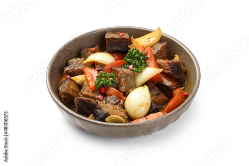 Plate with beef with vegetables isolated on white background