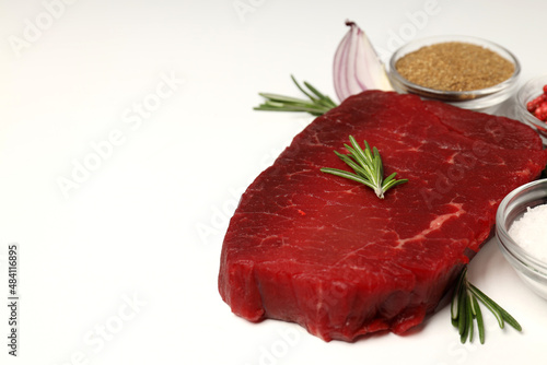 Concept of tasty food with raw beef steak on white background