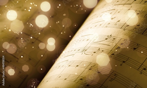 Old sheet with Christmas music notes as background bokeh