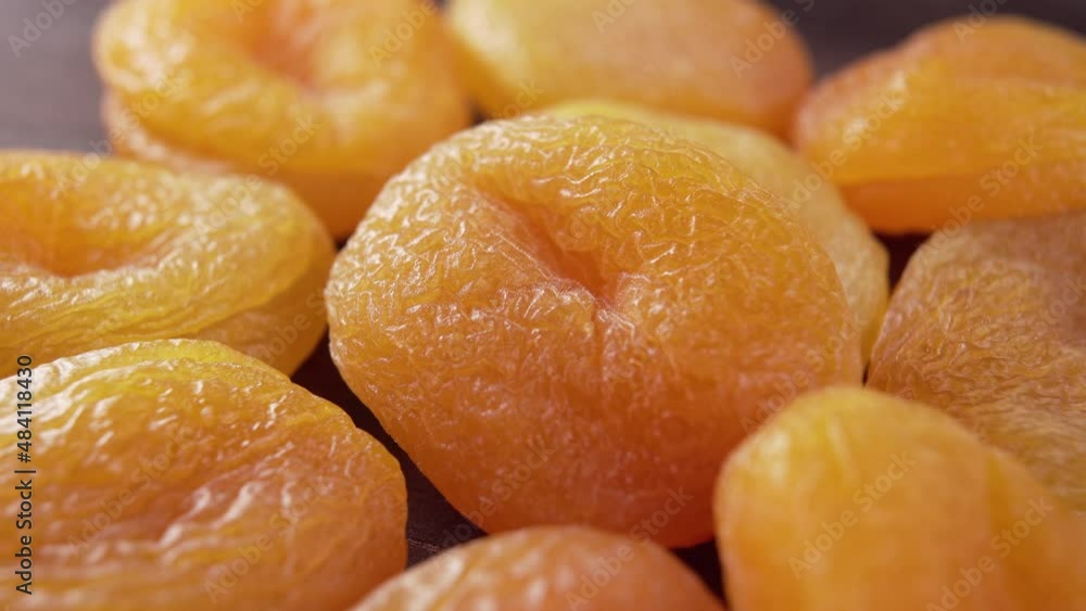 Heap of wrinkled dried apricots. Dry fruits. Macro. Rotation. Healthy food concept. Heap of wrinkled dried apricots. Dry fruits. Macro. Rotation. Healthy food concept.
