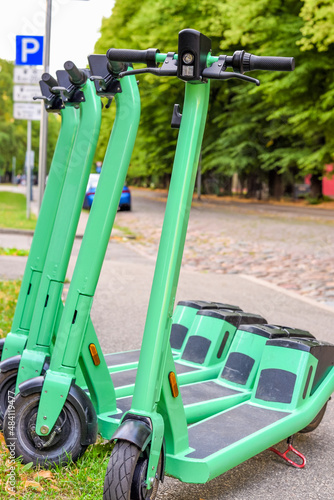 Electric scooters parked on the street of the city for rent and online booking in the application. Electric scooter eco-friendly transport in the city for sharing service.