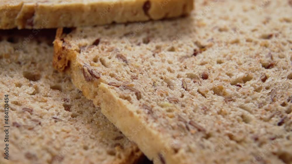 Sliced wheat whole grain bread close up. Macro. Textured porous baked surface. Rotation Sliced wheat whole grain bread close up. Macro. Textured porous baked surface. Rotation