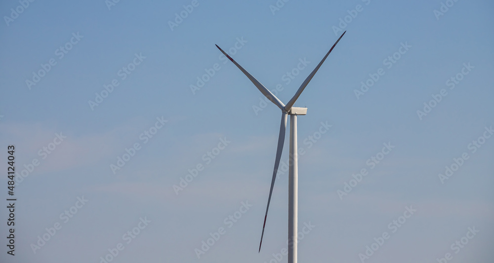 wind mill or also wind-turbine on wind farm in rotation to generate electricity energy on outdoor with sun and blue sky, conservation and sustainable energy concept wind mill or also wind-turbine on wind farm in rotation to generate electricity energy on outdoor with sun and blue sky, conservation and sustainable energy concept