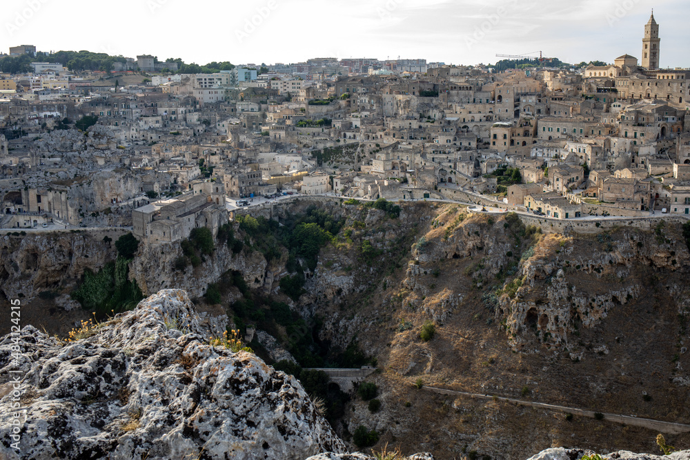 Panoramic view of Sassi di Matera a historic district in the city of Matera, well-known for their ancient cave dwellings from the Belvedere di Murgia Timone,  Basilicata, Italy