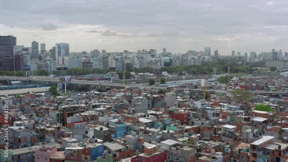 Aerial view Buenos Aires Argentina. Slums with downtown background with skyscrapers and skyline, poor neighborhoods with colorful houses and roads. Aerial view Buenos Aires Argentina. Slums with downtown background with skyscrapers and skyline, poor neighborhoods with colorful houses and roads.