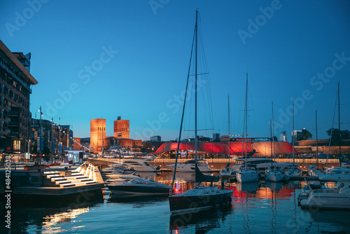 Oslo, Norway. Night View Embankment, Oslo City Hall And Moored Yachts Near Aker Brygge District. Summer Evening. Famous And Popular Place.Oslo, Norway. Night View Embankment, Oslo City Hall And Moored © Grigory Bruev