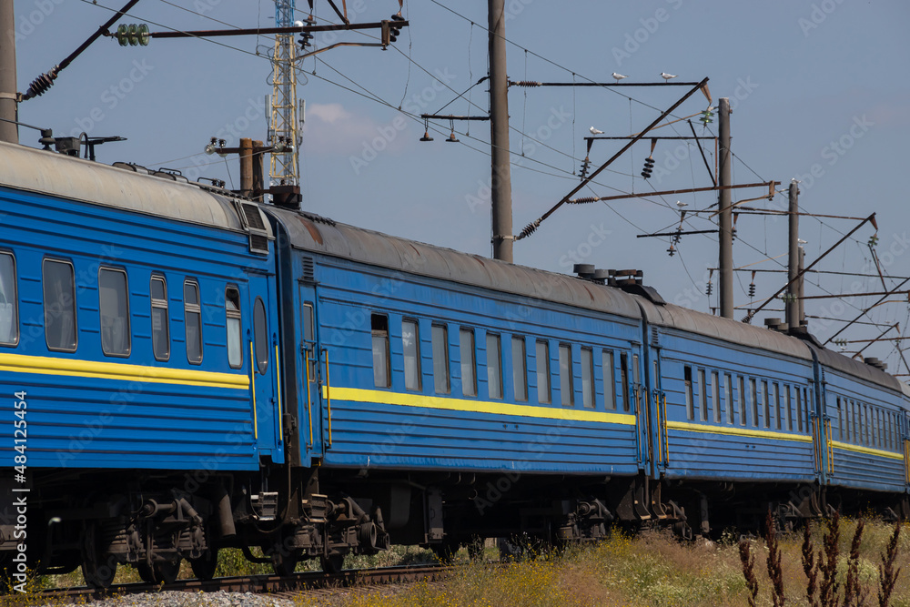 Fototapeta premium Old blue passenger train, carriages on a sunny summer day