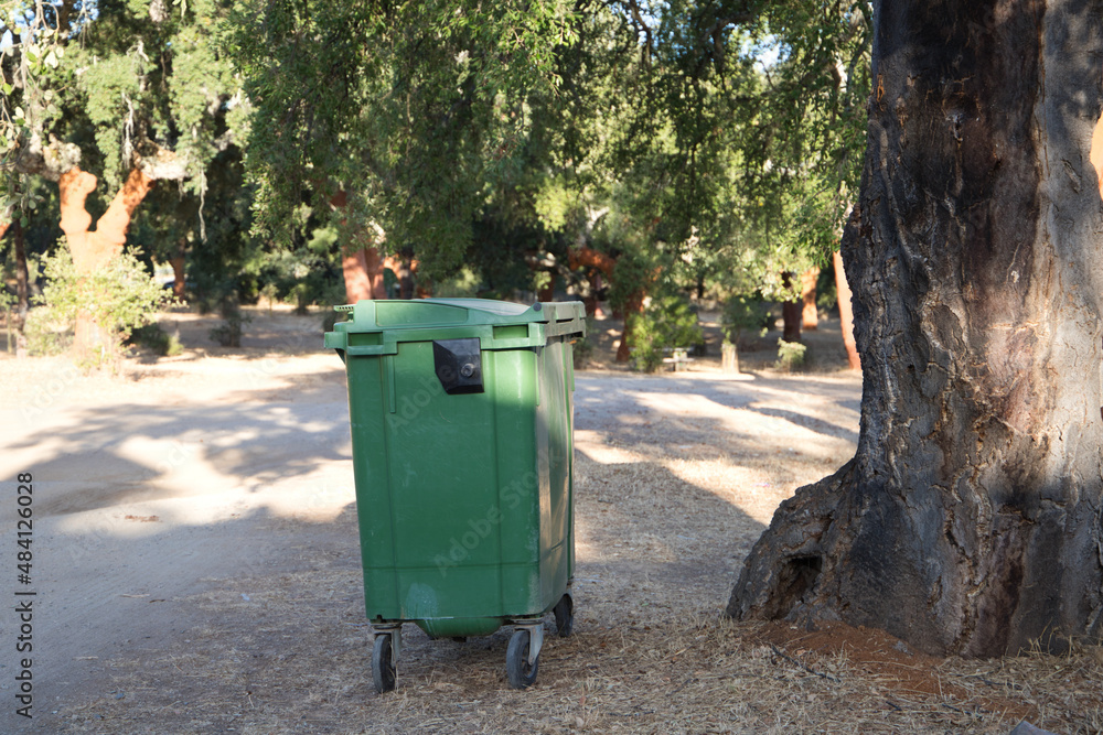 Waste container in a forest in order to recycle and not pollute the environment. Infectious control concept. Waste container in a forest in order to recycle and not pollute the environment. Infectious control concept.