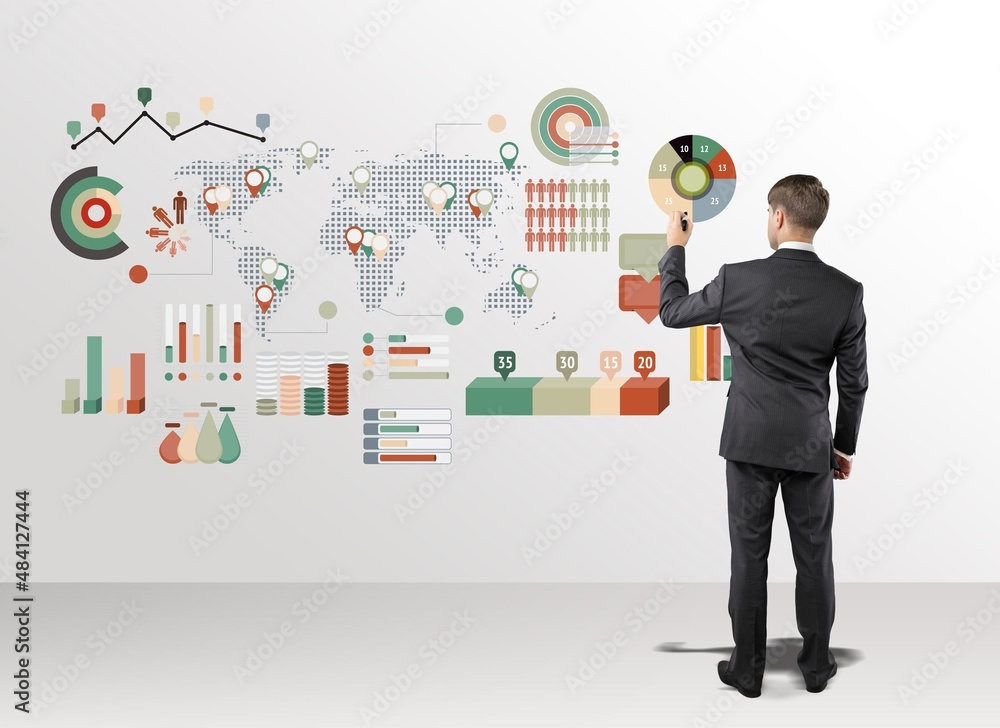 Young businessman wearing a suit and concrete wall with a business plan sketch Young businessman wearing a suit and concrete wall with a business plan sketch