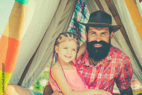 Happy family at camping. Tent outdoor. Happy childhood concept. Family time. Dad and daughter. Fatherhood photo