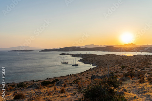 Magnificent landscape from the top point to the bay with yachts and the sun at sunset.