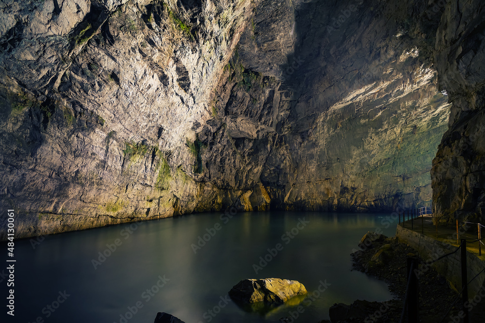 Long exposure photo of underground Planina cave in Slovenia with river