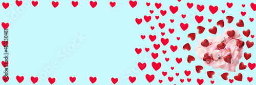 Red hearts, birds and flowers on a blue background. Festive banner for Valentine's day. copy space.