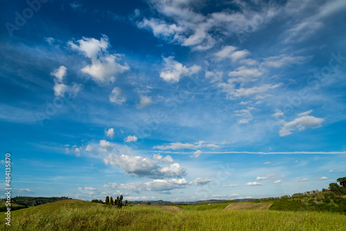 Tuscan countryside with blue sky and clouds