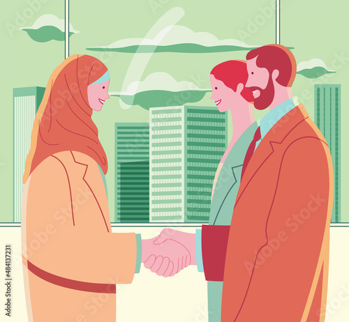 Young Muslim woman in hijab shaking hands with two colleagues. Multi-ethnic team. Workplace with large window overlooking skyscrapers.
