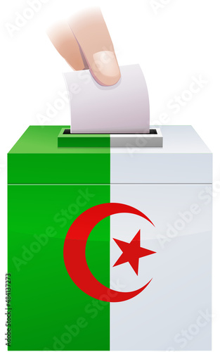 Election ballot box with the colors of the Algerian flag in which a ballot paper is slipped by the fingers of one hand	