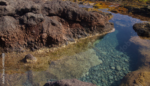 Gran Canaria, calm rock pools under steep cliffs of the north coast are 
separated from the ocean by volcanic rocks of platform constructed by old lava flows
Punta de Galdar area photo