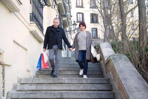 Elderly people walking with paper bags in their hands © luisrojasstock