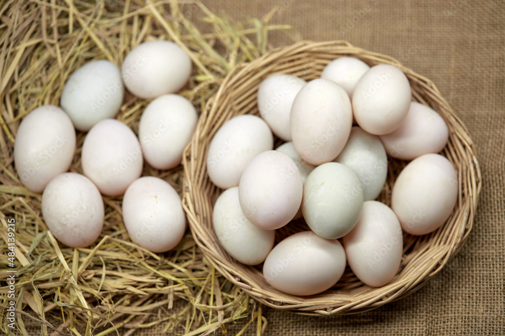 Close-up white eggs in a wicker basket Close-up white eggs in a wicker basket
