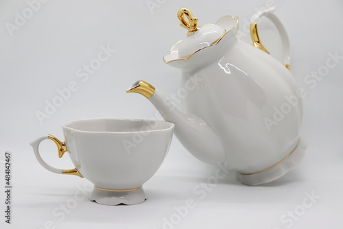 White porcelain teapot with cup