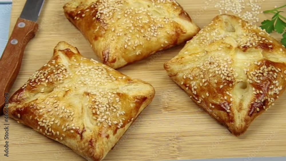 flaky with sesame seeds on a wooden board flaky with sesame seeds on a wooden board