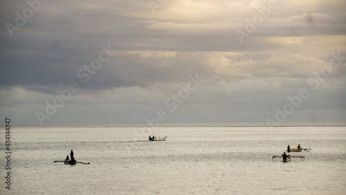Kupang, East Nusa Tenggara, Indonesia - January 21, 2022:
Fishermen on Kolbano beach, South Central Timor Regency, East Nusa Tenggara province, Indonesia, are seen at work on the afternoon of January  photo
