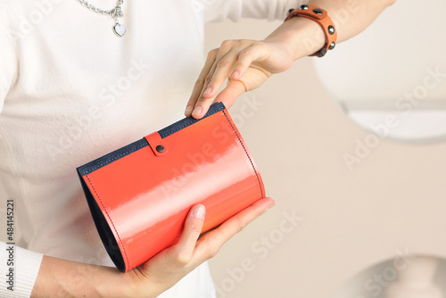 red leather purse close up photo in human hand