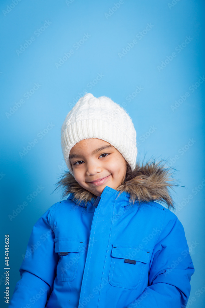 portrait on blue background of young Asian girl with smile looking at camera portrait on blue background of young Asian girl with smile looking at camera
