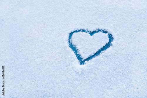 Heart in the snow. Drawing of the heart in winter