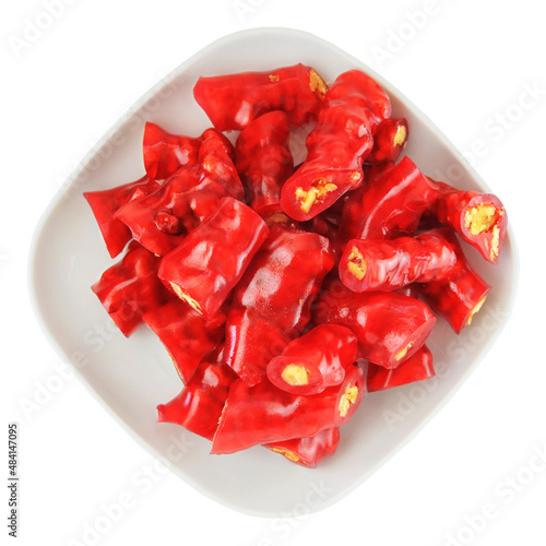 Traditional Georgian sweetness food. Churchkhela with walnuts in a plate isolated on white background. Top view. photo