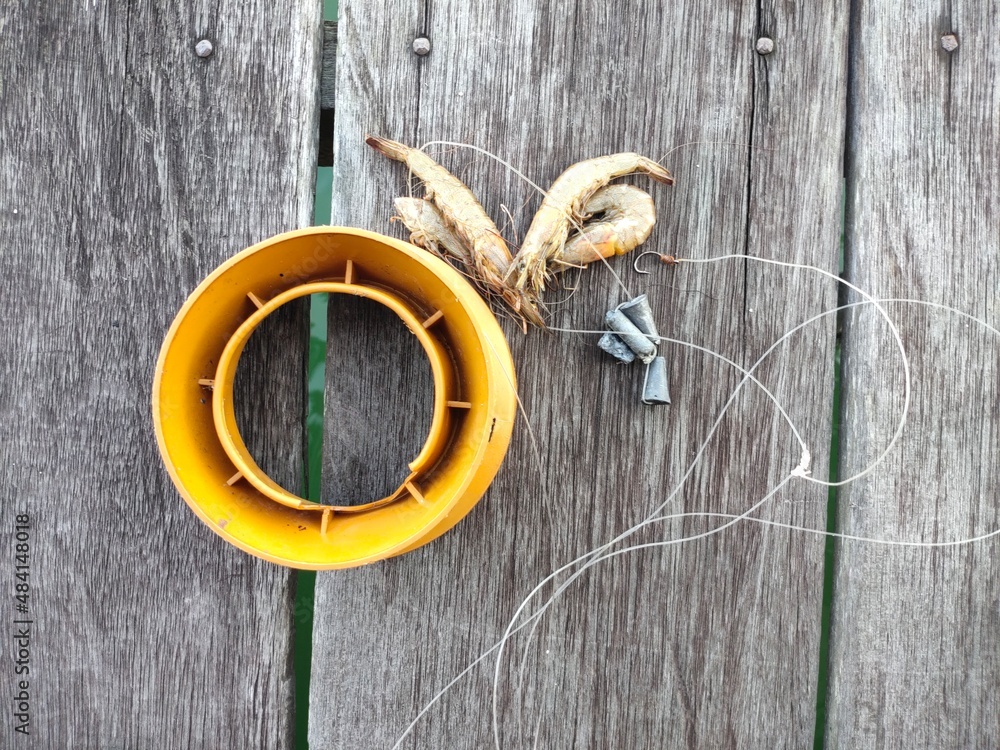 simple fishing rod with shrimp bait and ballast made of tin simple fishing rod with shrimp bait and ballast made of tin