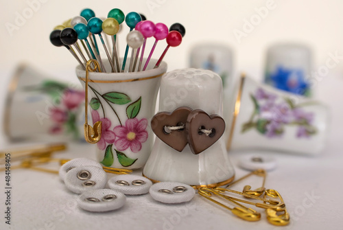 heart-shaped buttons, thimble and safety pins