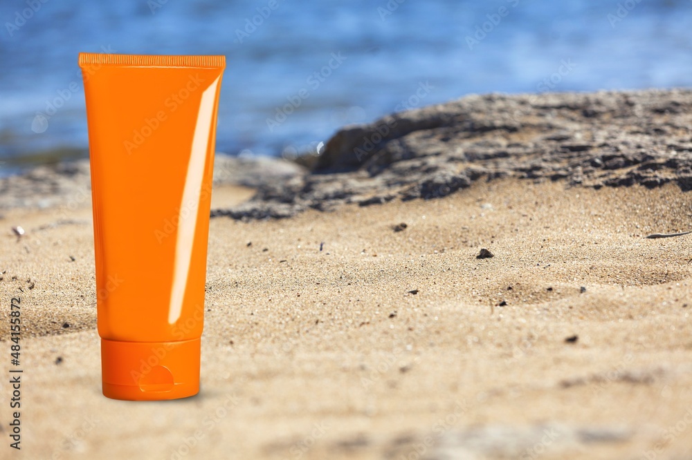 empty cosmetic skin care cream on sand beach with sea side background travel vacation accessory empty cosmetic skin care cream on sand beach with sea side background travel vacation accessory